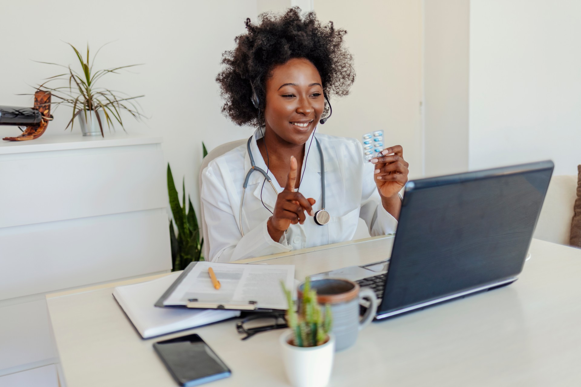 Black female doctor using laptop in video call of telemedicine.